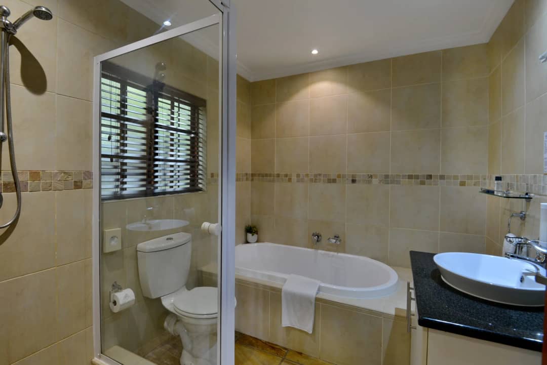 Bathroom with a bath, shower and basin