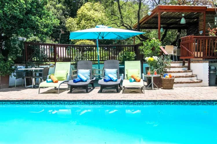 The pool, with loungers and umbrellas beside the deck