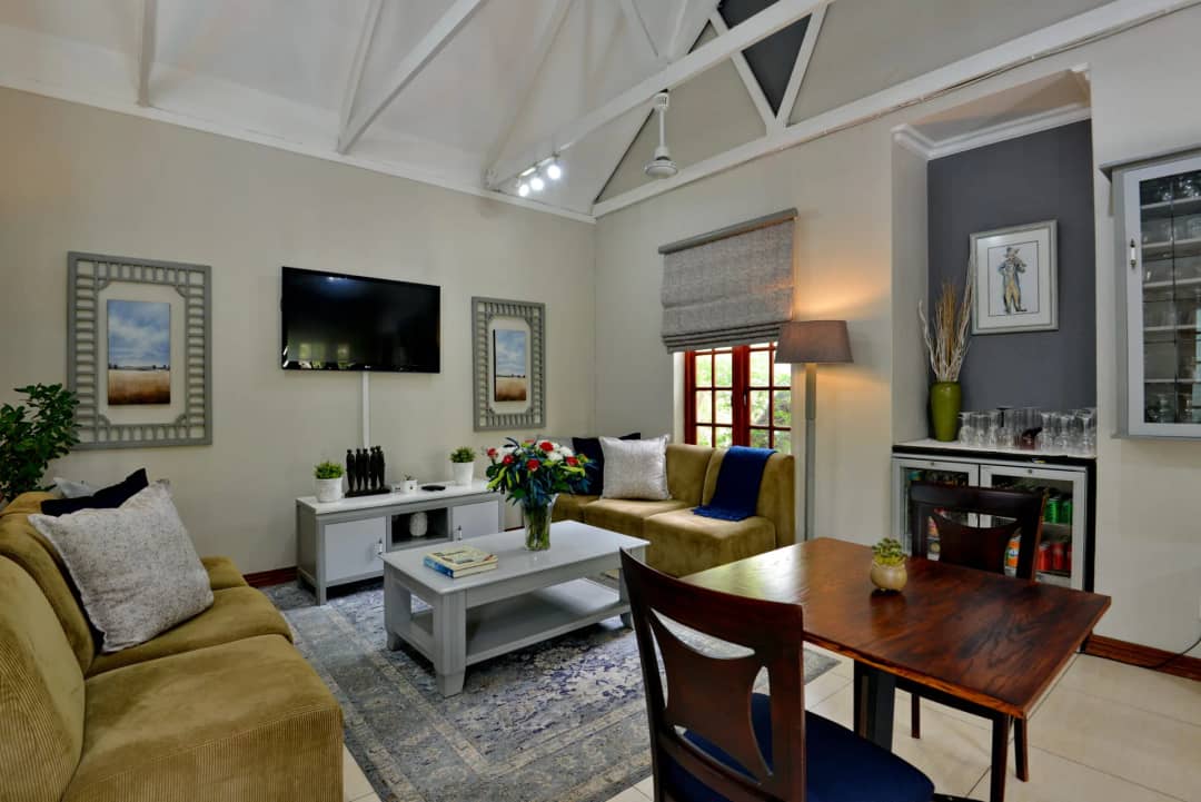 Lounge with sofas, a TV and a dining table